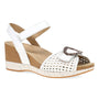 Sandal by Dansko, white wedge, cork-look sole, ankle strap with brown buckle, woven front. Comfort footbed visible.