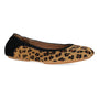 Flat shoe, Dansko Madisen, leopard print fabric with black heel, tan sole, visible arch support, on white background.