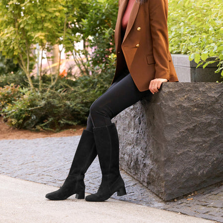 Model wearing Avenue Tall Metatarsal in color Black Suede