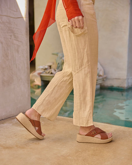 Model wearing Solstice Cross Slide Metatarsal in color Dark Tan