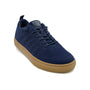 Shoe, navy Merino wool, brown sole, laces, pull tab. Kiama by Woolloomooloo. Supportive sole visible, front-side angle.